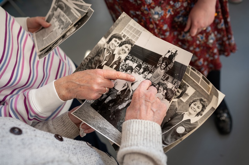 Person looking at black and white photos of Southampton-FA-cup-winners