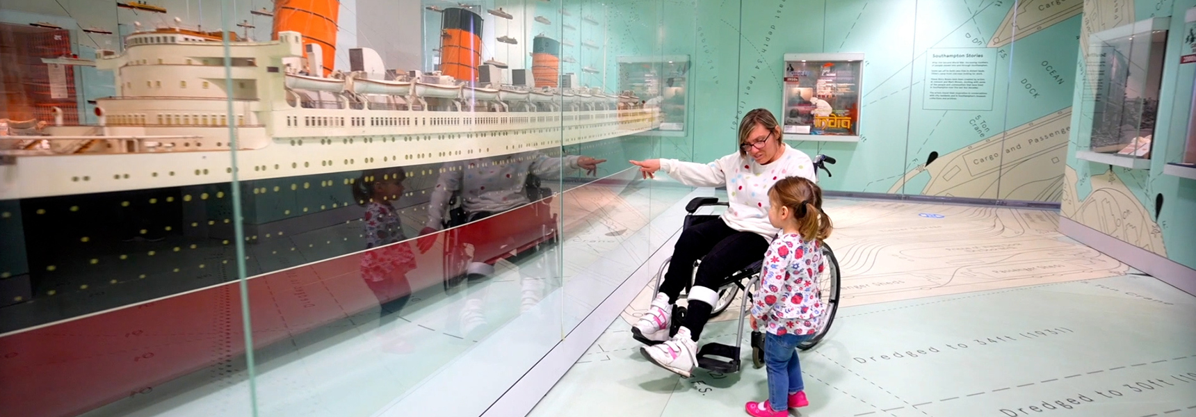 Family viewing the Queen Mary model liner